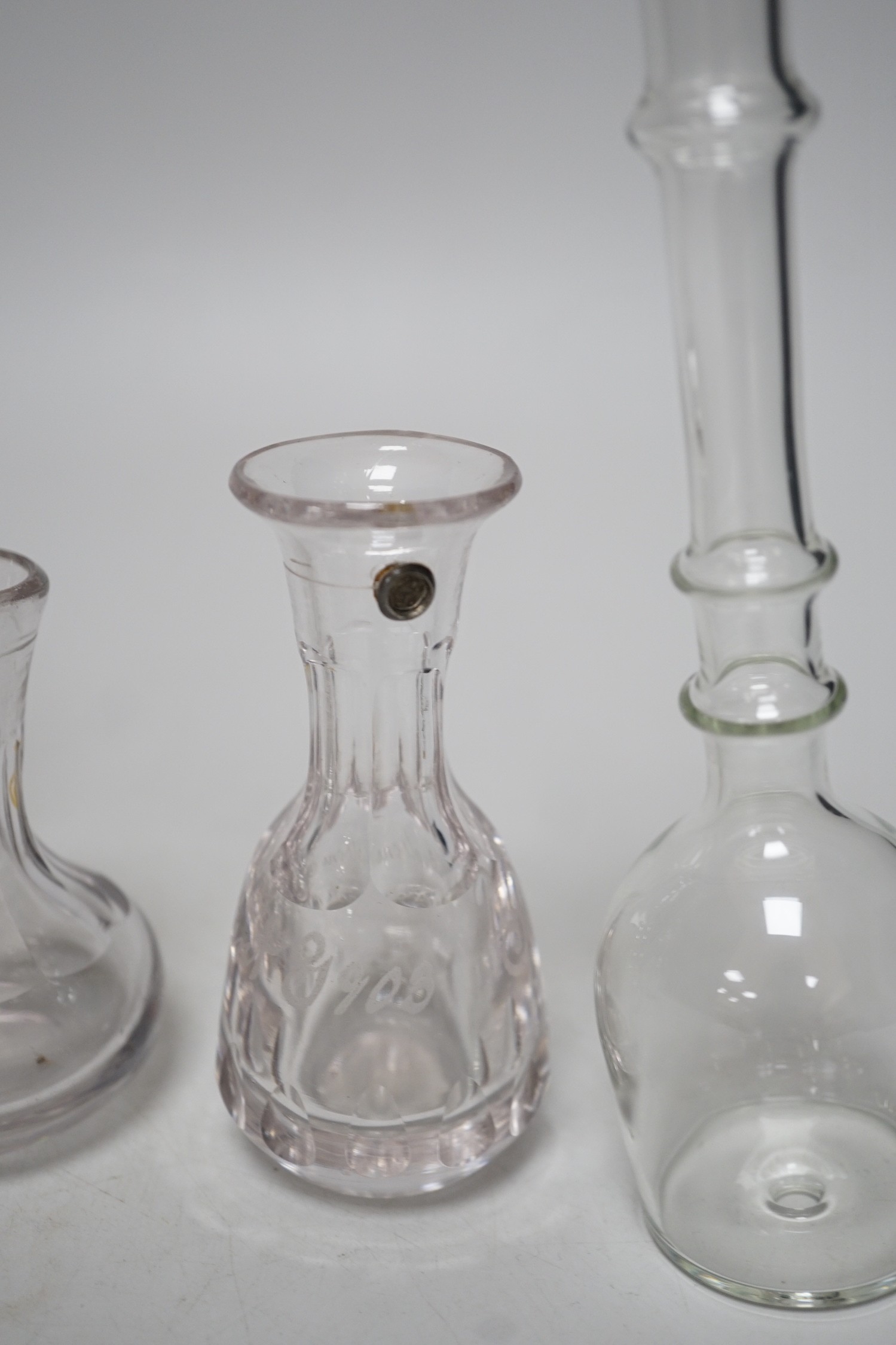 Three 19th century glass measures and two toddy lifts (5), tallest 19cms high